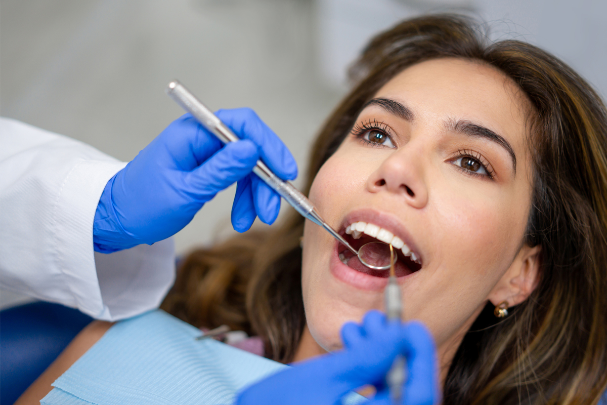 Dental professional demonstrating oral hygiene techniques