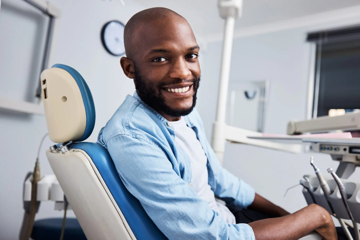 Patient sitting in a dental chair and smiling