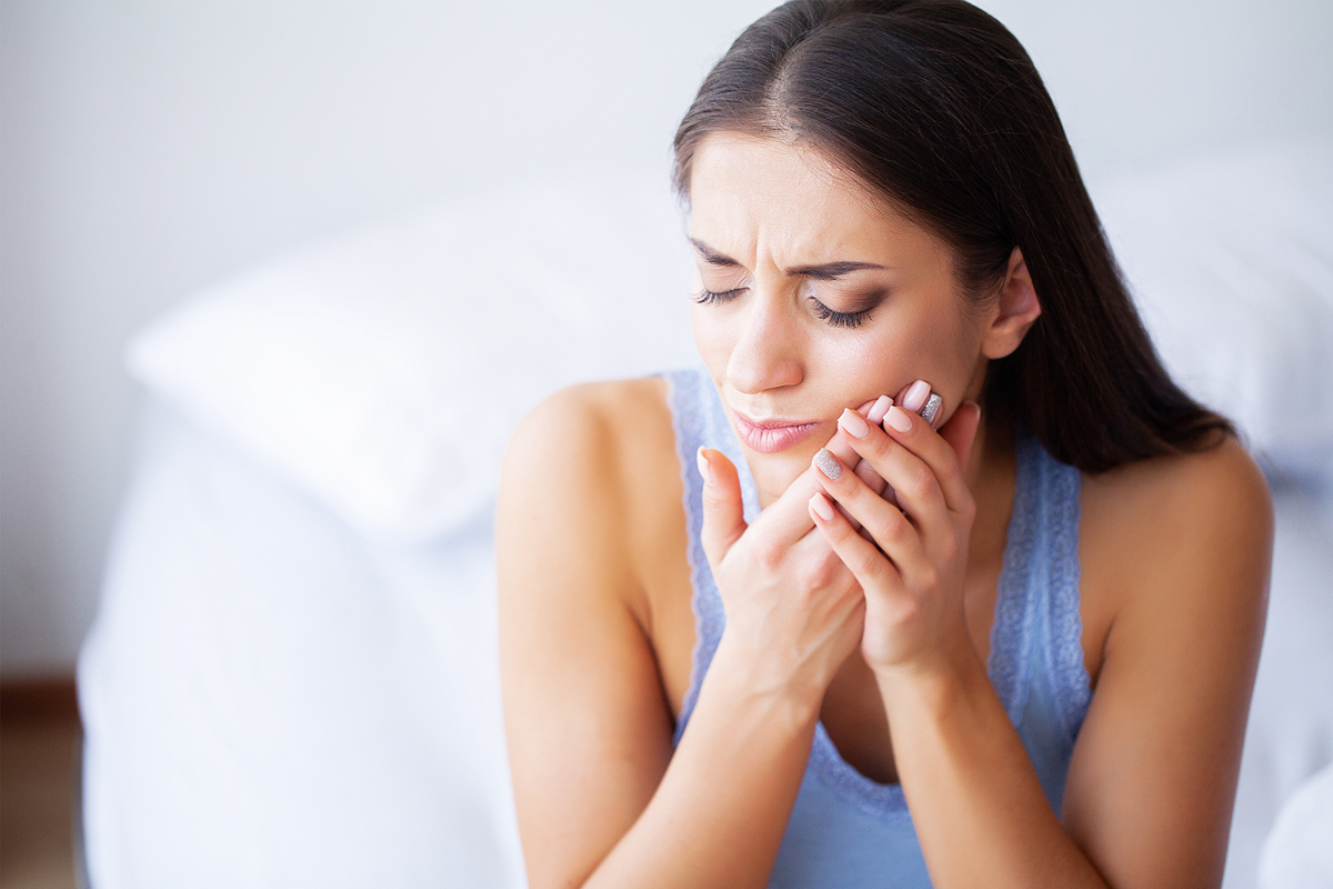 Woman experiencing tooth discomfort from decay