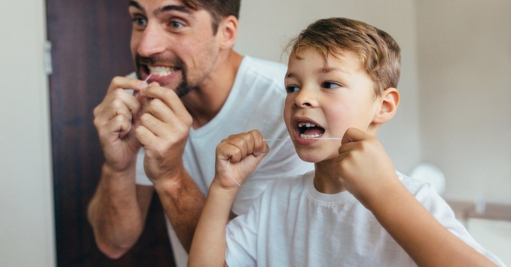 Father and child practicing healthy dental habits