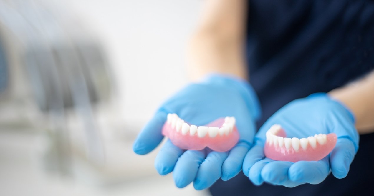 Dental professional providing denture care guidance