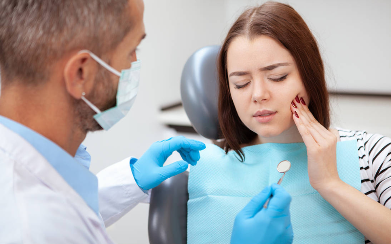 Patient discussing dental concerns during an examination