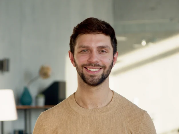 Smiling man with beard outdoors
