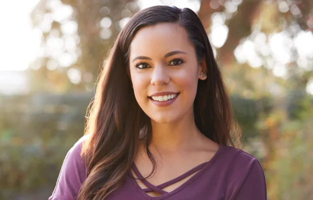 Smiling woman with long hair outdoors