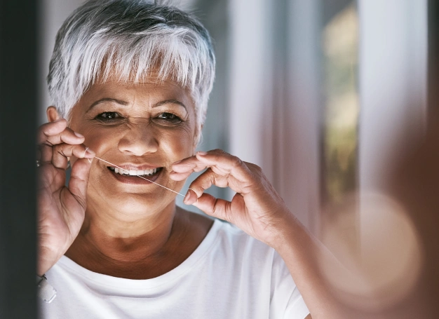 Older woman flossing