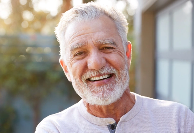 Older man smiling outdoors