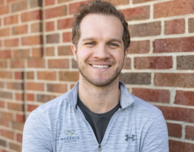 Dr. Alex Clark smiling outdoors