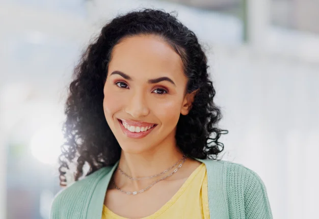 Woman with curly hair smiling with white teeth