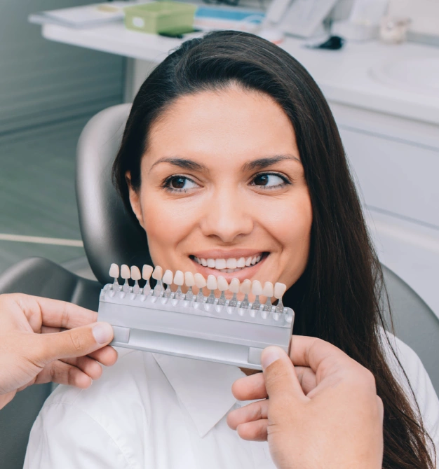Patient comparing porcelain veneer shade options