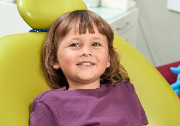 Child sitting on a dental chair