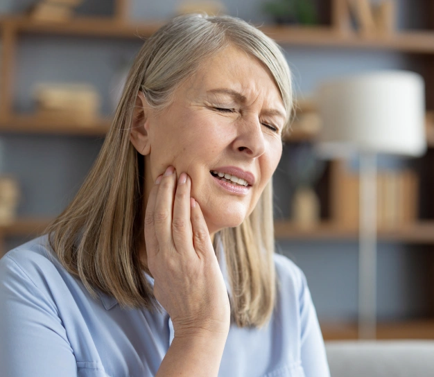 Woman holding her cheek in pain