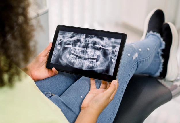 Patient viewing digital dental X rays on a tablet
