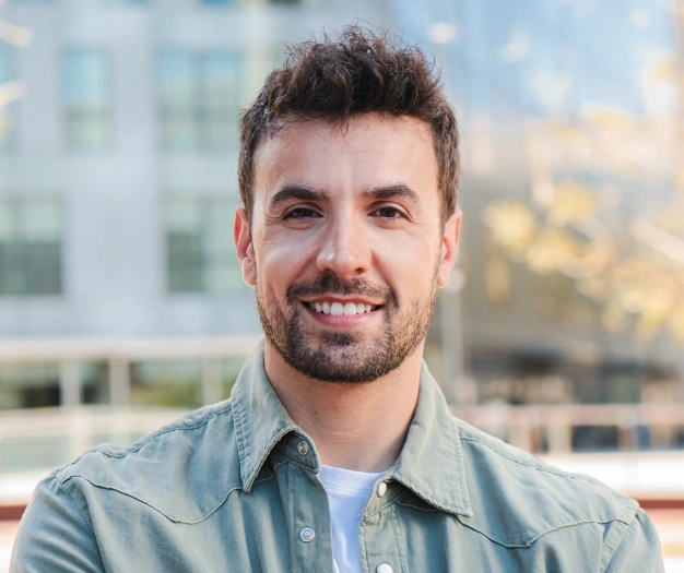 Man smiling with bright white teeth after treatment