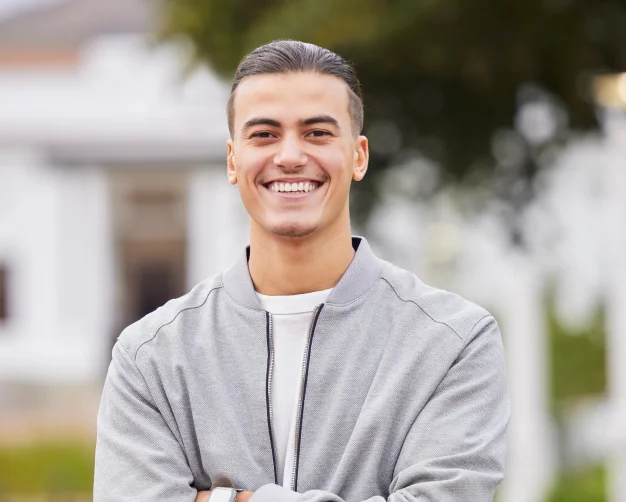 Smiling man outdoors showing his teeth