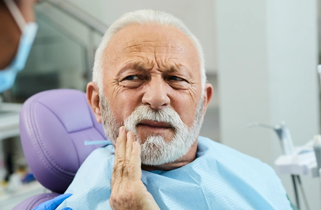 Senior man after tooth extraction treatment