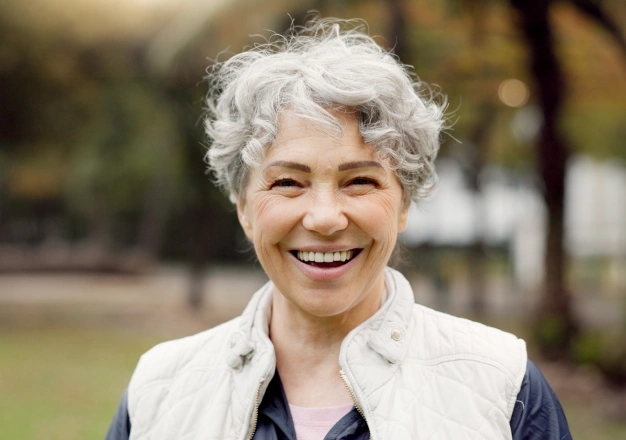 Older woman smiling outdoors