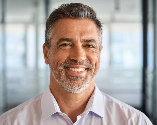 Older man smiling indoors