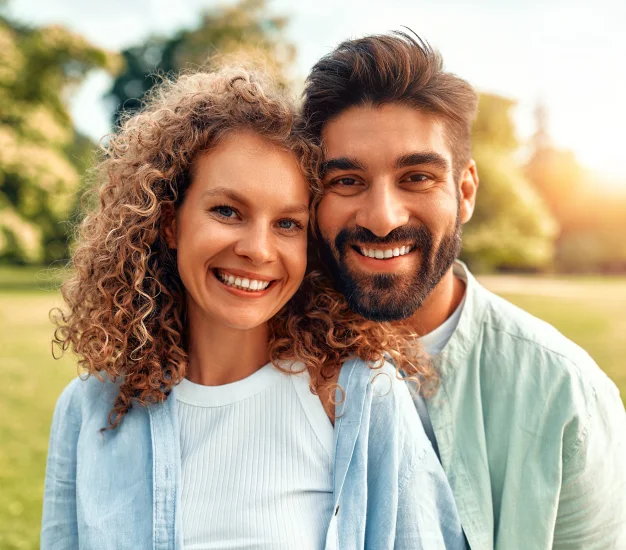 Couple smiling together, representing the benefits of dental cleaning