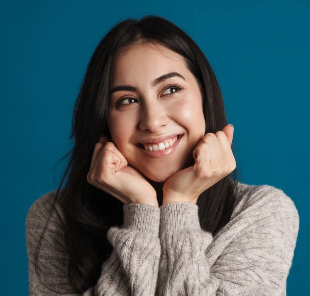 Woman smiling with her hand resting on her cheek