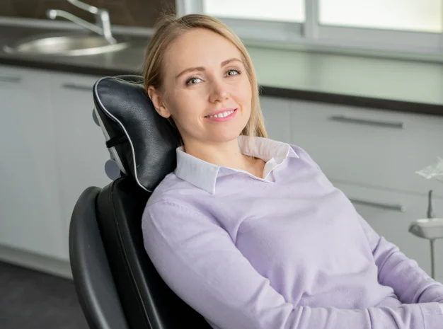 Woman sitting in a dental chair during an oral health examination
